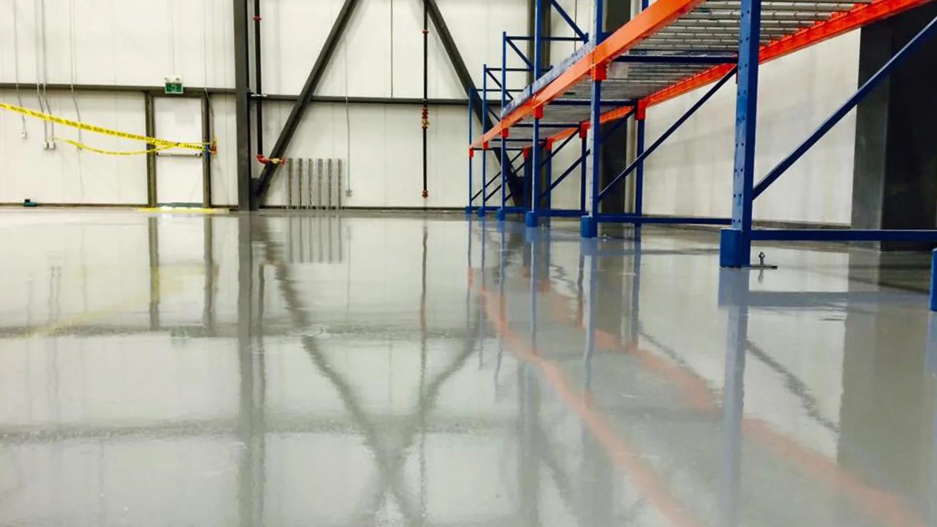 Completed solid-colour coating beneath storage racks at the PPG plant in Moncton, New Brunswick