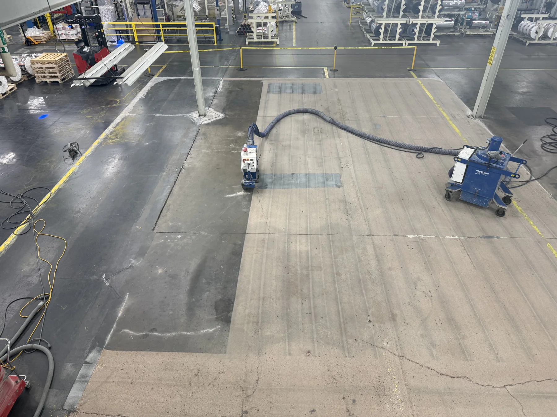 Shot-blasting equipment mechanically preparing an industrial concrete floor