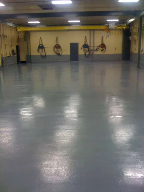 Blue static-control floor beneath technical equipment