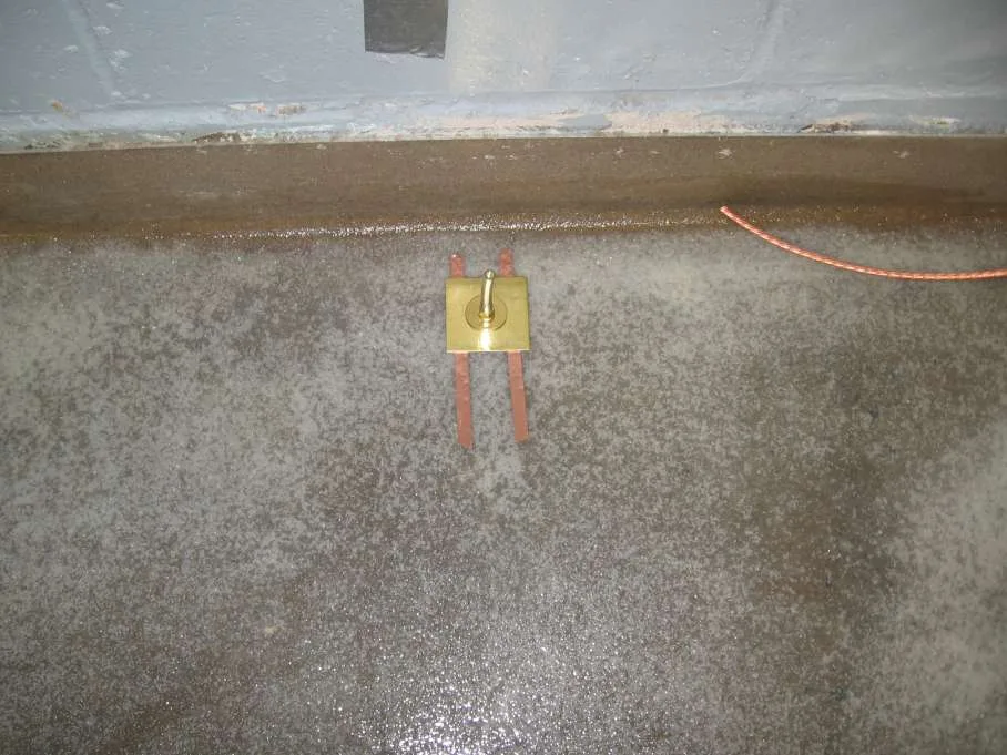 Copper grounding connection installed as part of a static-control flooring system