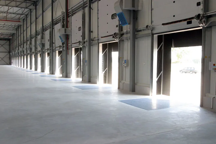 Treated exposed concrete floor in a vehicle service area