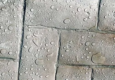 Water beading on the surface of treated concrete