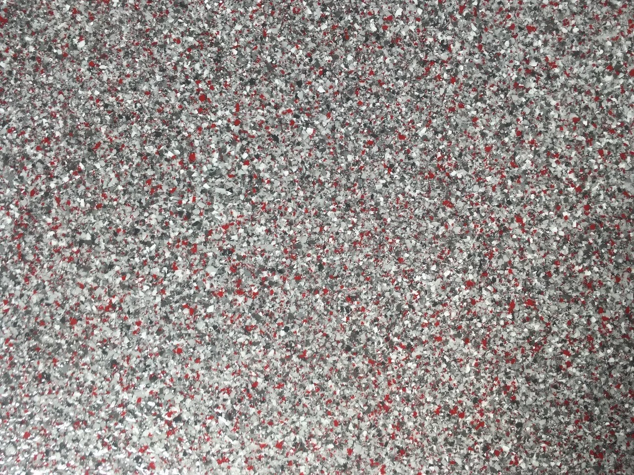 Close view of a grey, white and black decorative flake floor