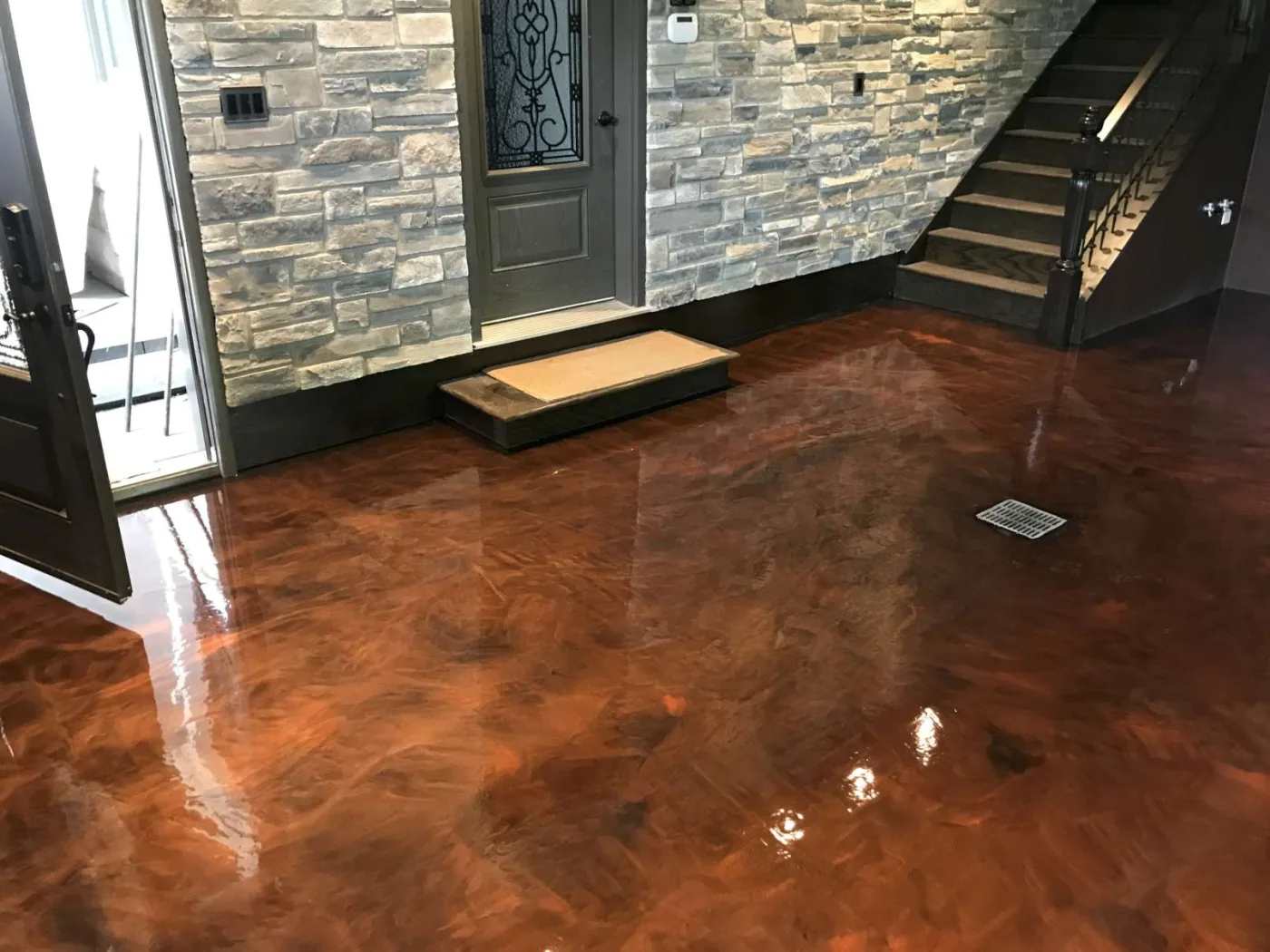 Copper-toned metallic floor in a finished entrance area