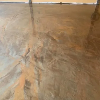 Glossy copper-toned metallic floor with layered hand-applied movement