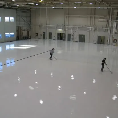 Large bright industrial floor finished with a seamless white coating
