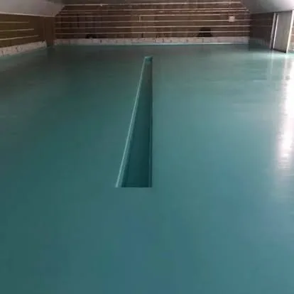 Turquoise seamless resin floor installed across a large open interior