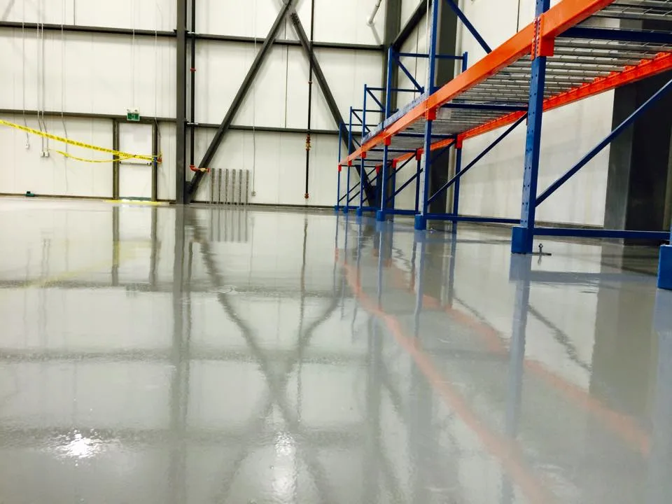 Light-grey epoxy floor beneath warehouse storage racks
