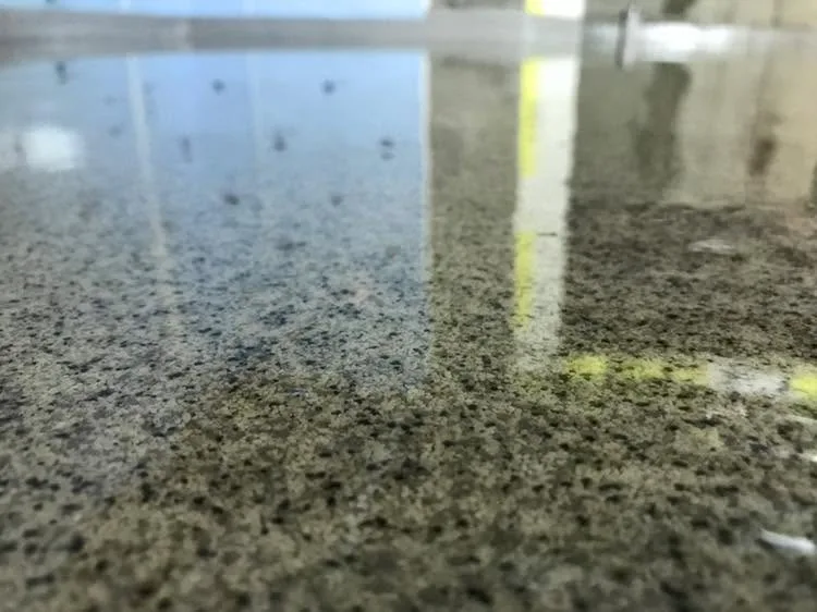 Close-up of a dark multi-tonal quartz floor with a glossy finish
