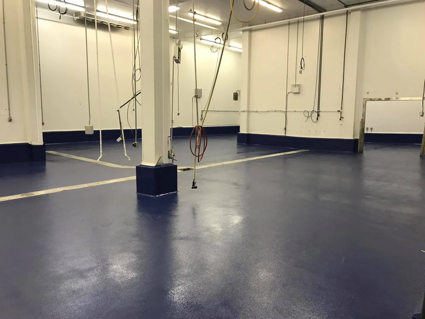 Dark blue solid-colour broadcast floor with matching cove base