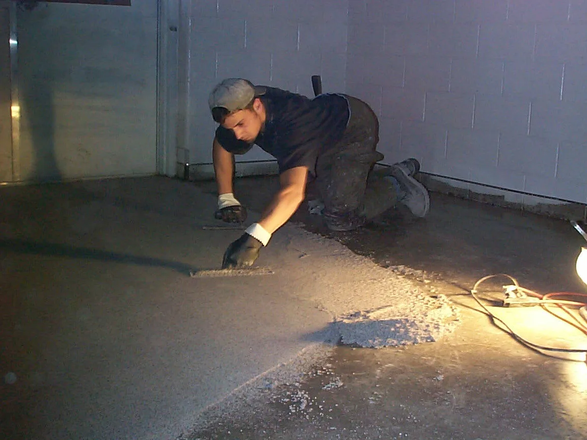 Installer troweling an aggregate-filled epoxy floor