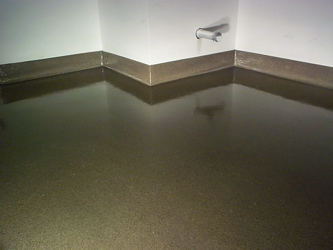 Dark troweled quartz floor with an integral cove transition