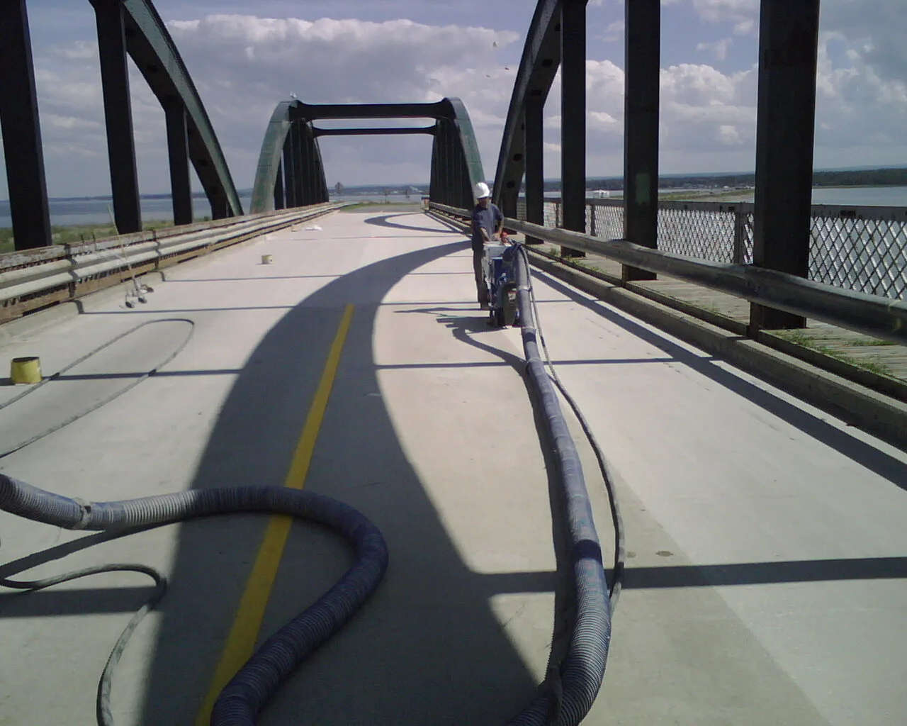 Shot-blasting equipment operating along a prepared bridge deck