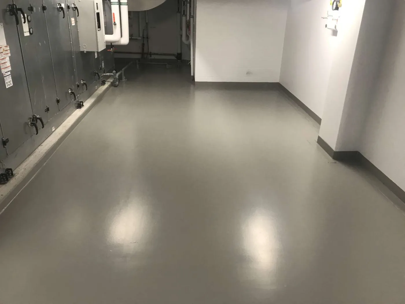 Smooth grey waterproofing membrane in a mechanical room